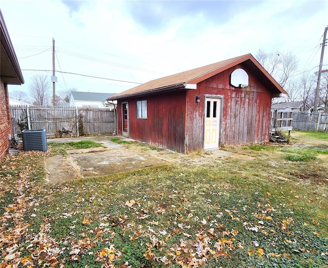 view of outbuilding with a yard and central AC