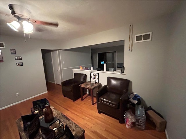 living room with wood-type flooring and ceiling fan