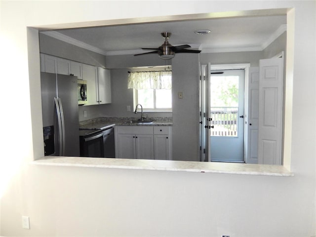 kitchen featuring appliances with stainless steel finishes, ornamental molding, ceiling fan, sink, and white cabinets