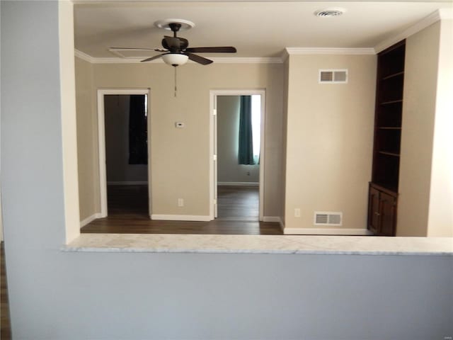 empty room with ceiling fan, dark hardwood / wood-style floors, and crown molding