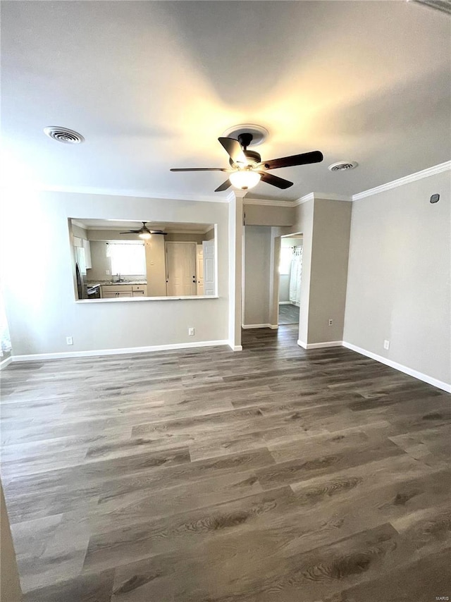 unfurnished living room with wood-type flooring and crown molding