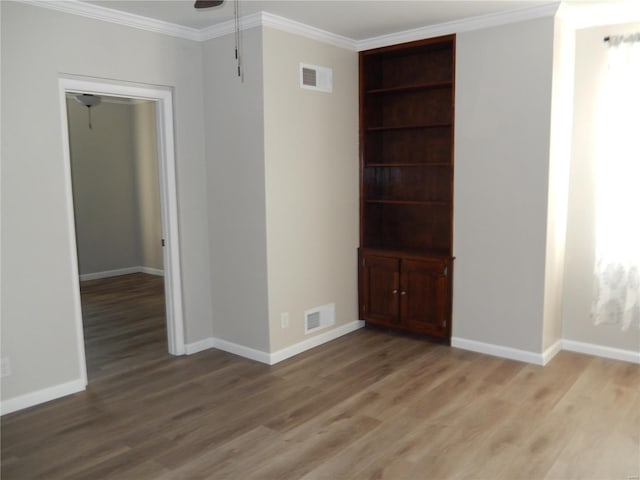 spare room featuring hardwood / wood-style flooring, ceiling fan, and ornamental molding