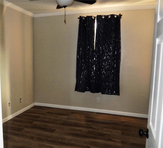 spare room with dark wood-type flooring and ornamental molding