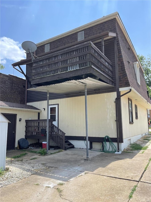 exterior space featuring a balcony and a deck