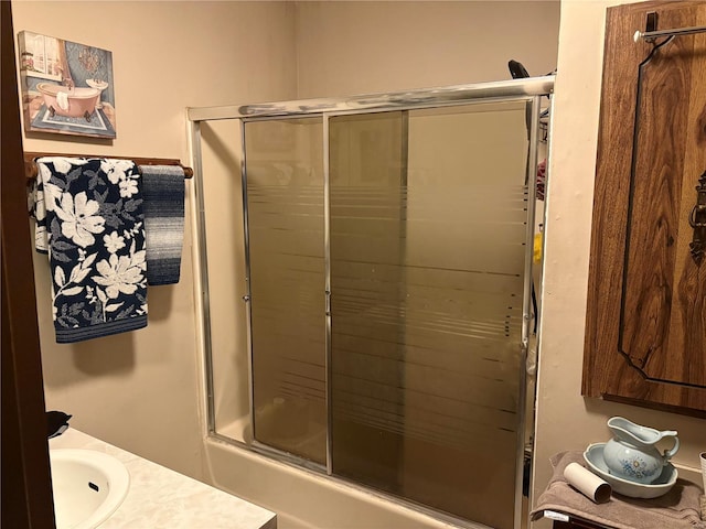 bathroom featuring vanity and a shower with shower door