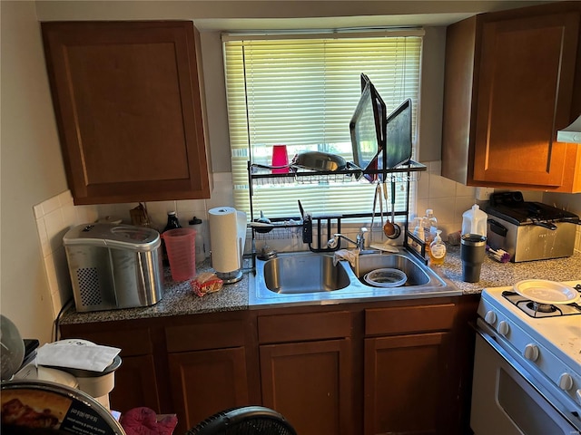 kitchen featuring white electric range oven, backsplash, and sink