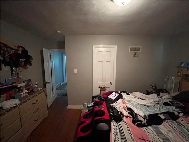 bedroom with dark hardwood / wood-style flooring