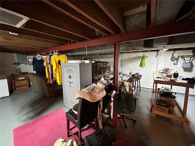 basement featuring a workshop area and electric panel