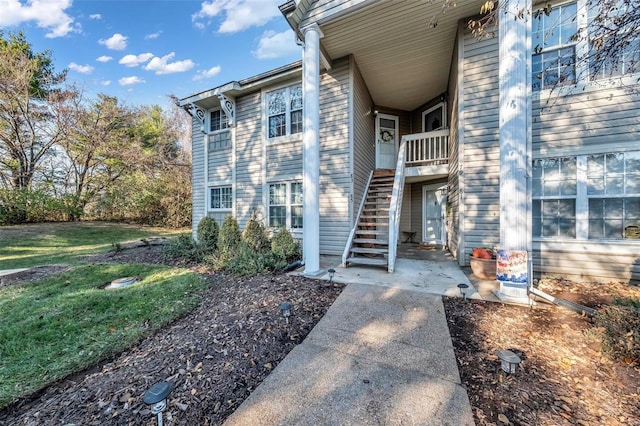 entrance to property featuring a lawn