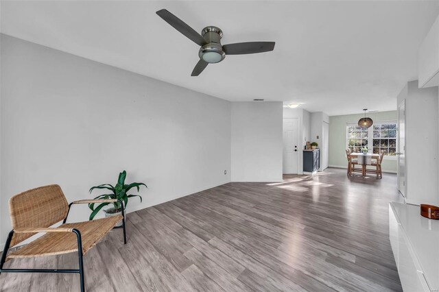 sitting room featuring a ceiling fan and wood finished floors