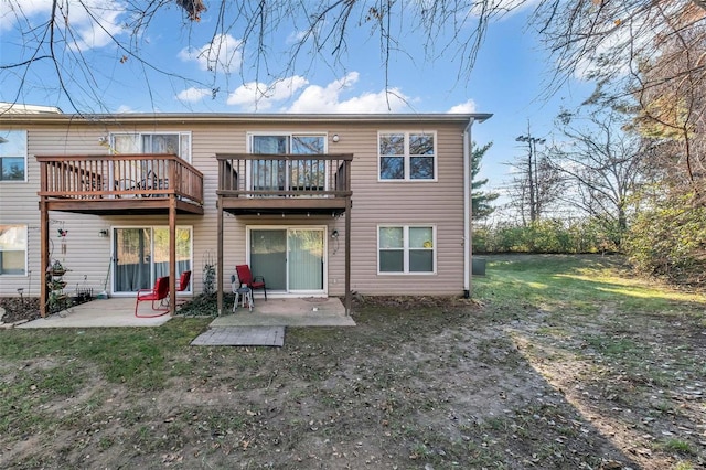 back of property with a patio area and a lawn