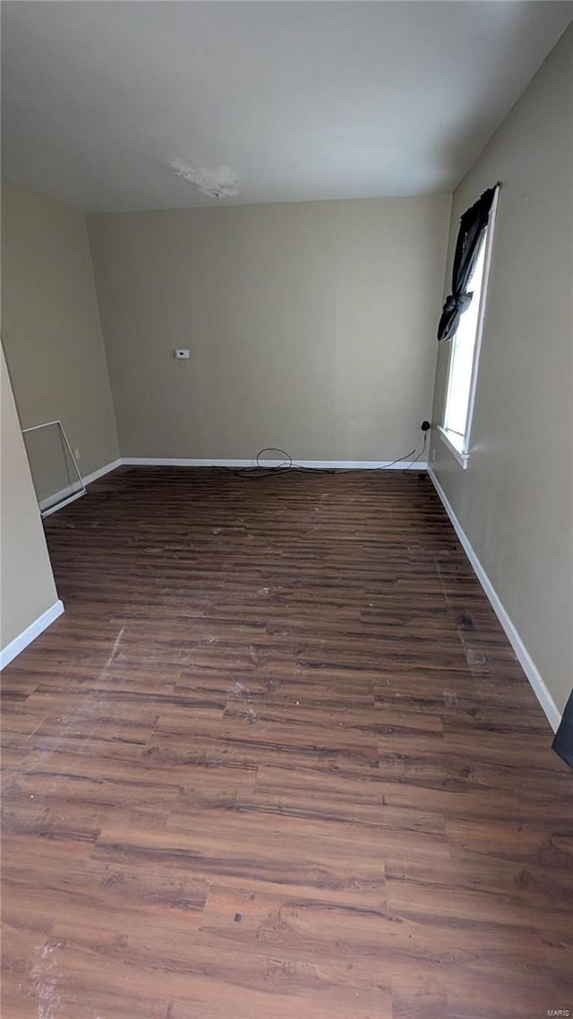 spare room with dark hardwood / wood-style flooring