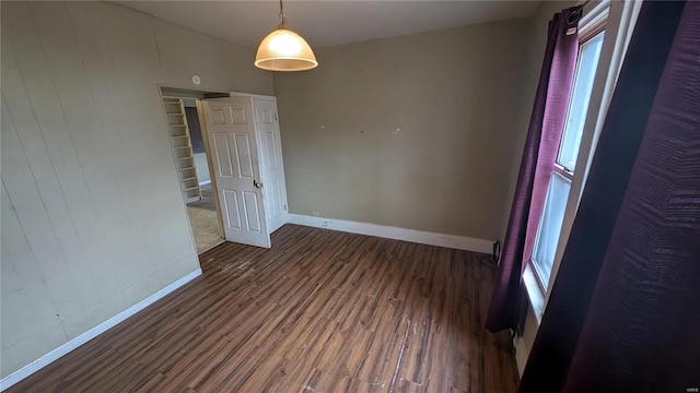 spare room with dark hardwood / wood-style flooring