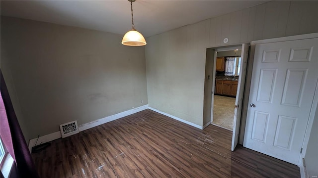 unfurnished room featuring dark hardwood / wood-style flooring