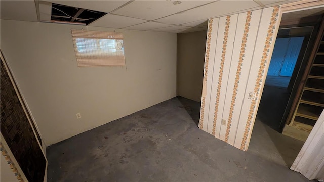 basement featuring a drop ceiling