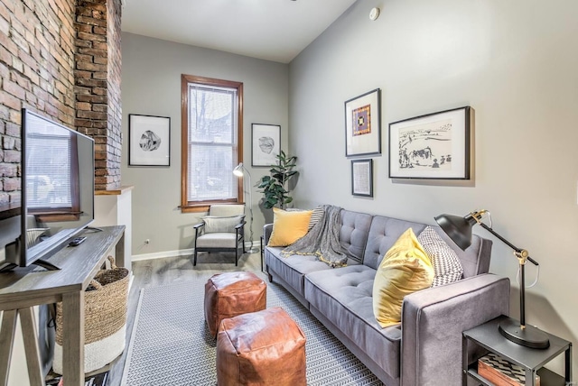 living room with wood-type flooring, a wealth of natural light, and vaulted ceiling