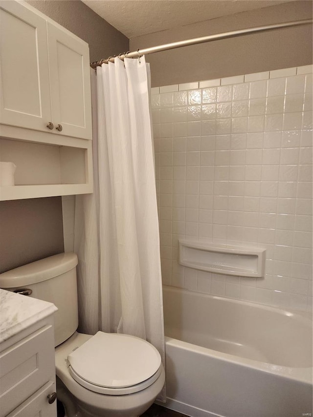 full bathroom with shower / bath combo with shower curtain, vanity, a textured ceiling, and toilet