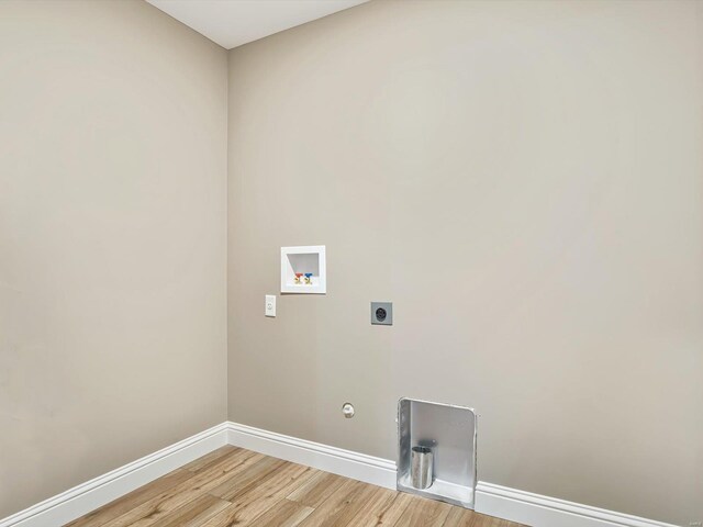 clothes washing area with washer hookup, electric dryer hookup, hookup for a gas dryer, and wood-type flooring