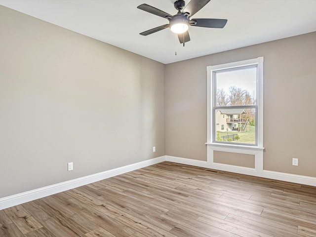 empty room with ceiling fan and light wood-type flooring