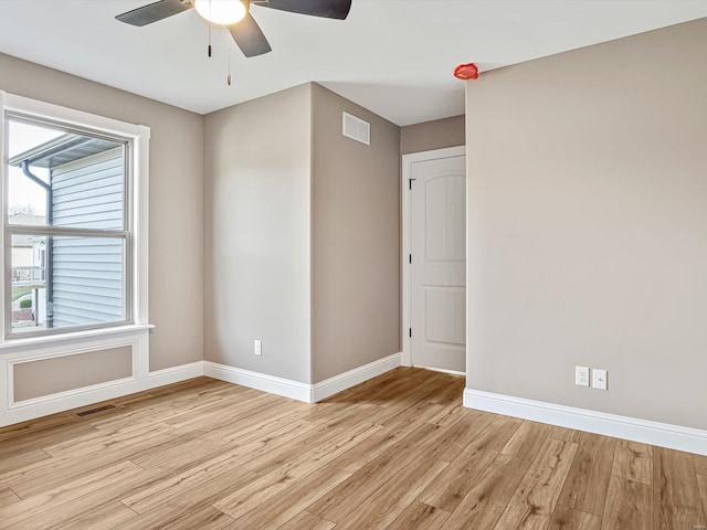 spare room featuring ceiling fan and light hardwood / wood-style flooring