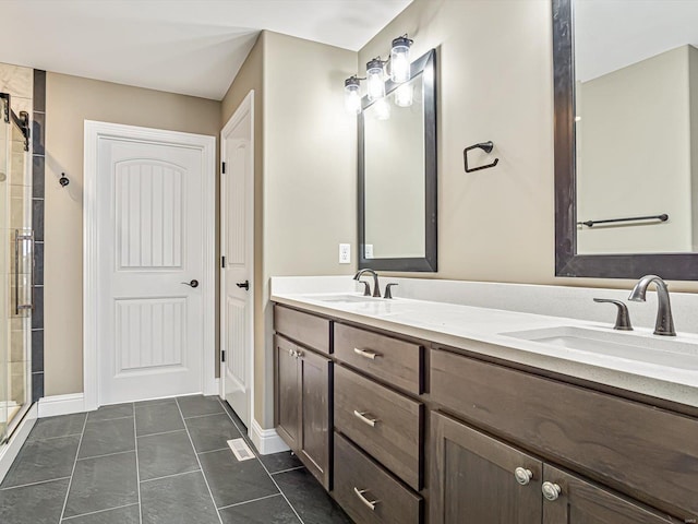 bathroom featuring tile patterned floors, vanity, and a shower with shower door