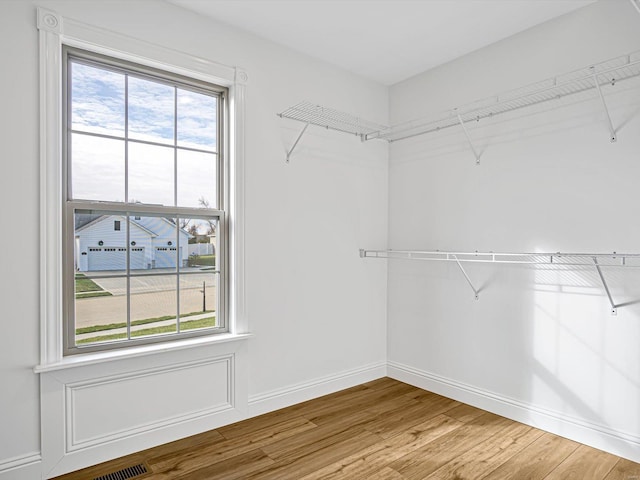 spacious closet featuring hardwood / wood-style flooring