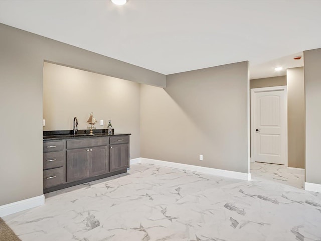 bar featuring dark brown cabinets and sink