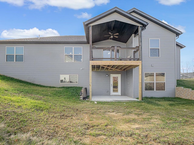 back of property featuring a lawn, ceiling fan, and a patio