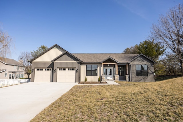 view of front of property featuring an attached garage, driveway, fence, and a front lawn