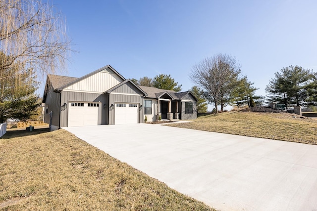 view of front of property with a garage, board and batten siding, a front lawn, and concrete driveway