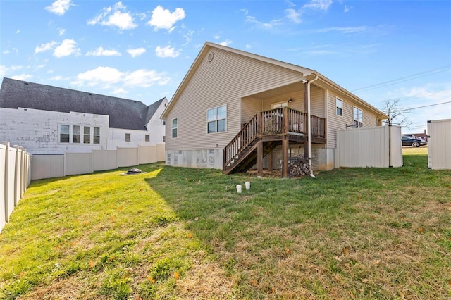 rear view of house featuring a yard, stairway, and a fenced backyard