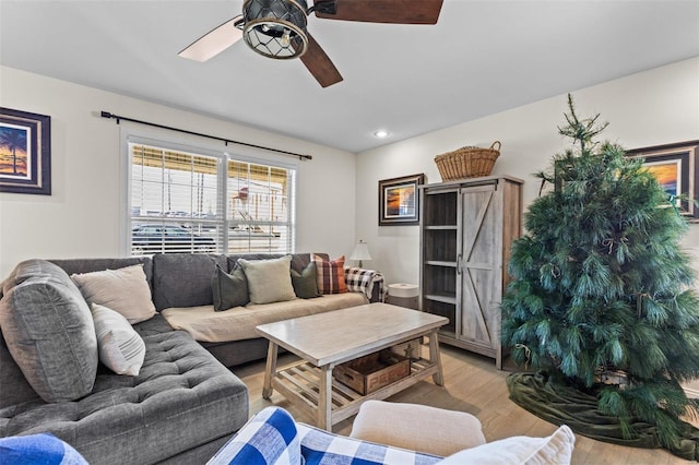 living area with a ceiling fan, wood finished floors, and recessed lighting