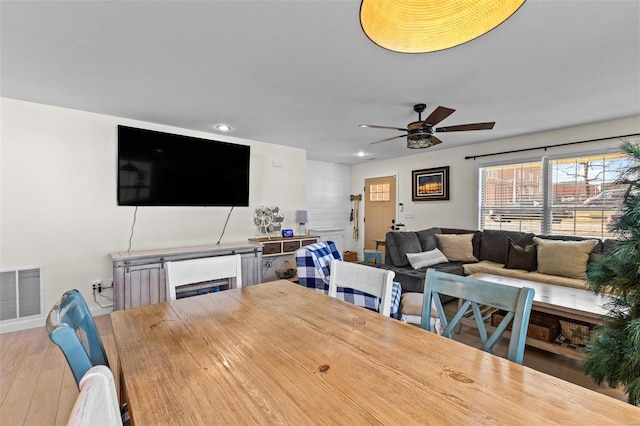 dining room featuring hardwood / wood-style flooring, ceiling fan, visible vents, and recessed lighting