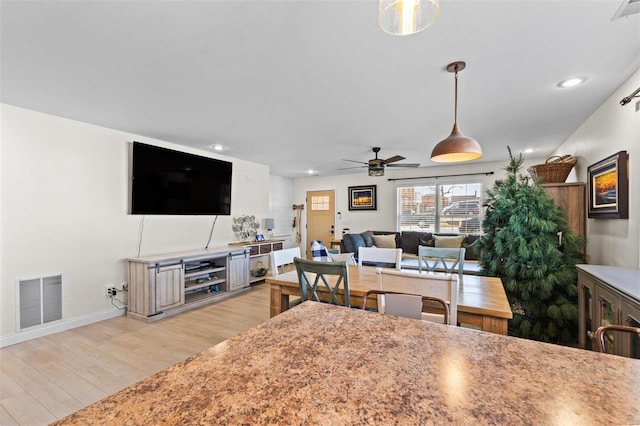 kitchen featuring light wood finished floors, recessed lighting, visible vents, hanging light fixtures, and a ceiling fan