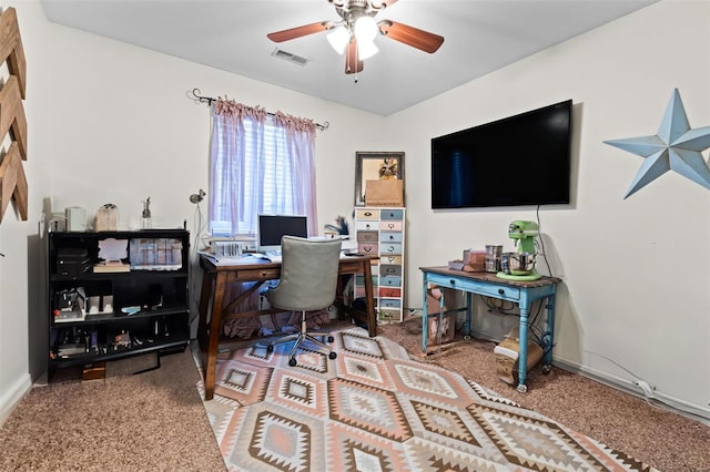 office space with a ceiling fan, baseboards, visible vents, and carpet flooring