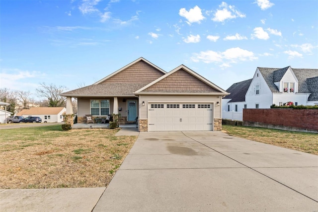 craftsman house with concrete driveway, stone siding, an attached garage, a porch, and a front yard