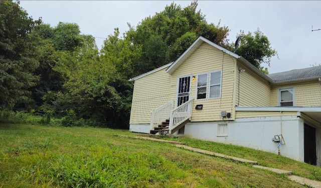 view of property exterior with a yard