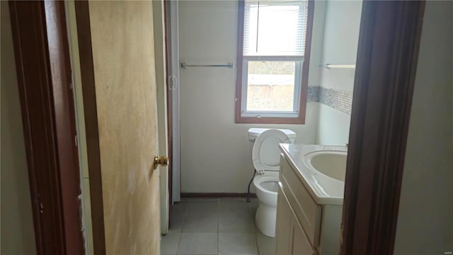 bathroom featuring tile patterned floors, vanity, and toilet