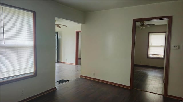 unfurnished room featuring dark hardwood / wood-style floors and ceiling fan