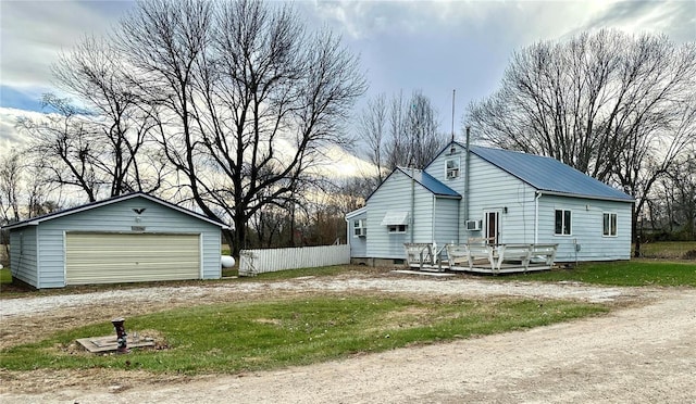 exterior space with an outbuilding, a deck, and a garage