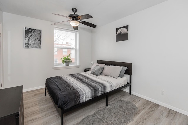 bedroom with ceiling fan and light wood-type flooring