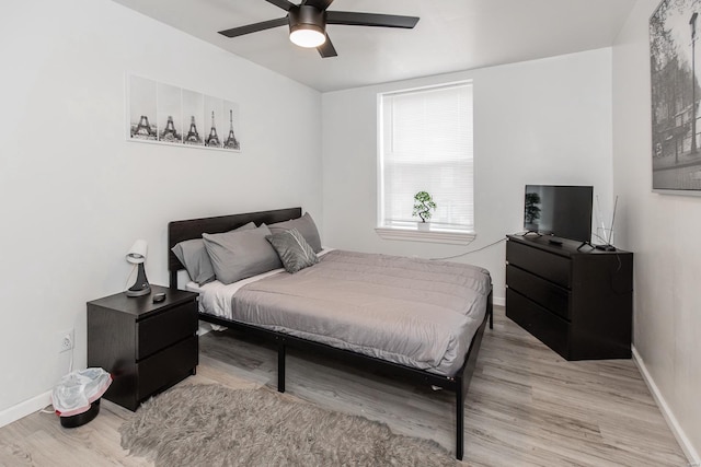 bedroom with ceiling fan and light hardwood / wood-style flooring