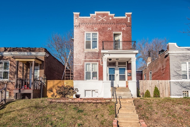 view of front of house featuring a balcony