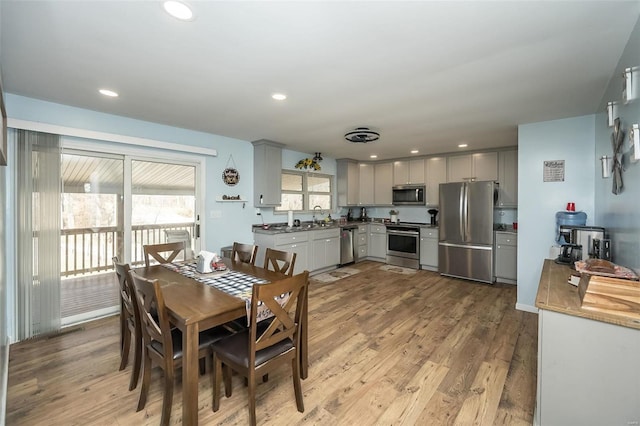 dining room featuring light hardwood / wood-style flooring and sink