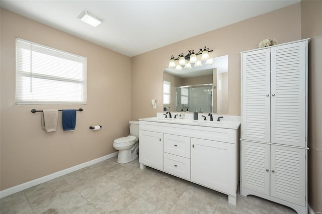 bathroom featuring vanity, toilet, walk in shower, and a wealth of natural light