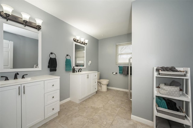 bathroom with tile patterned floors, vanity, and toilet