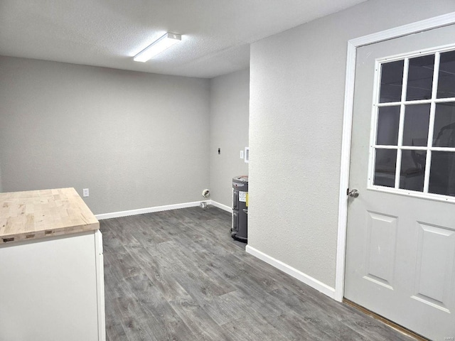 washroom featuring dark hardwood / wood-style flooring, hookup for an electric dryer, and a textured ceiling