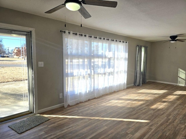 interior space featuring hardwood / wood-style floors, a textured ceiling, and ceiling fan