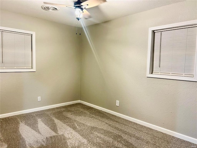 empty room featuring ceiling fan and carpet floors