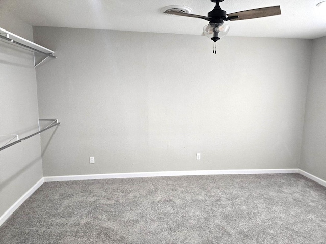 spacious closet with carpet flooring and ceiling fan